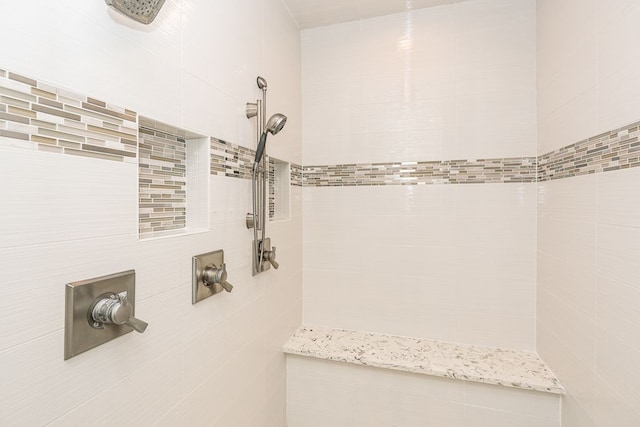 bathroom with a tile shower