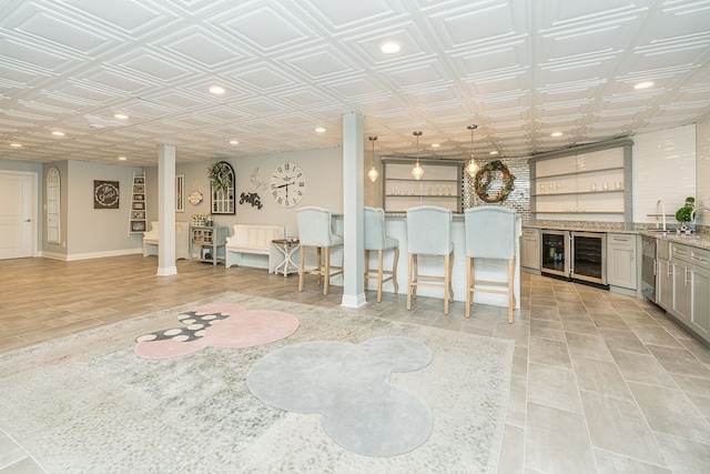 unfurnished living room featuring beverage cooler and sink