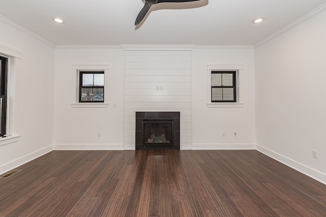 unfurnished living room with a large fireplace, dark wood-type flooring, and crown molding