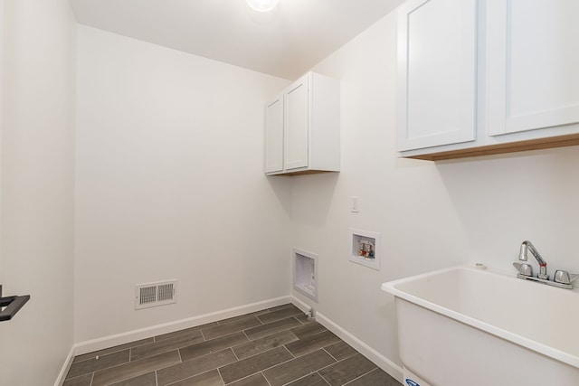 laundry area featuring sink, cabinets, and washer hookup