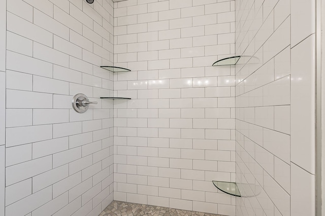 bathroom with a tile shower