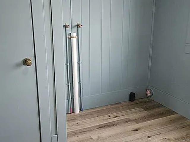 clothes washing area featuring light hardwood / wood-style flooring