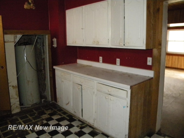 kitchen with white cabinetry and water heater