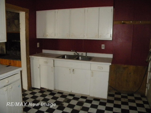 kitchen featuring white cabinets and sink