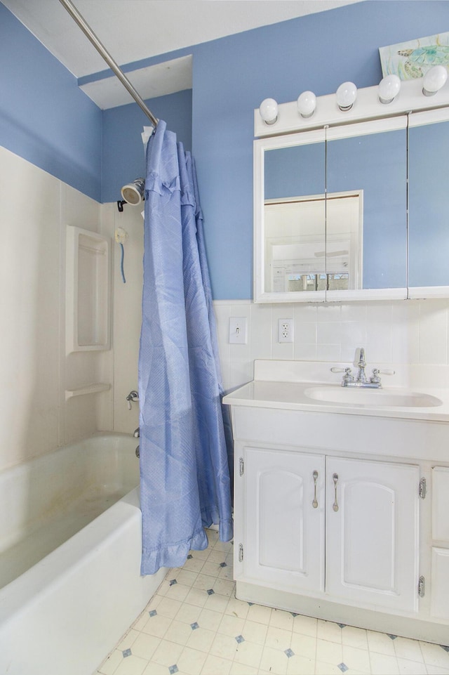 bathroom featuring shower / bath combo, vanity, and tasteful backsplash