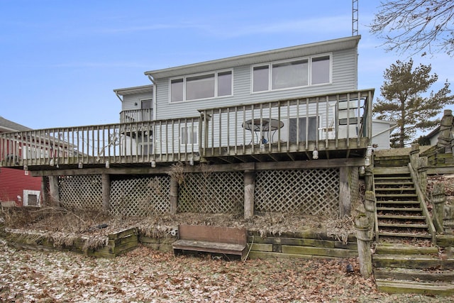 rear view of property featuring a wooden deck