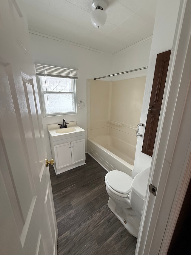 full bathroom featuring hardwood / wood-style flooring, vanity, toilet, and shower / washtub combination