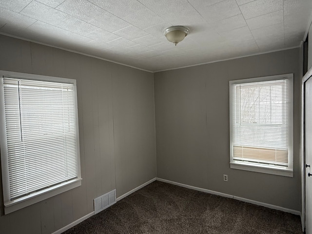 carpeted spare room with crown molding