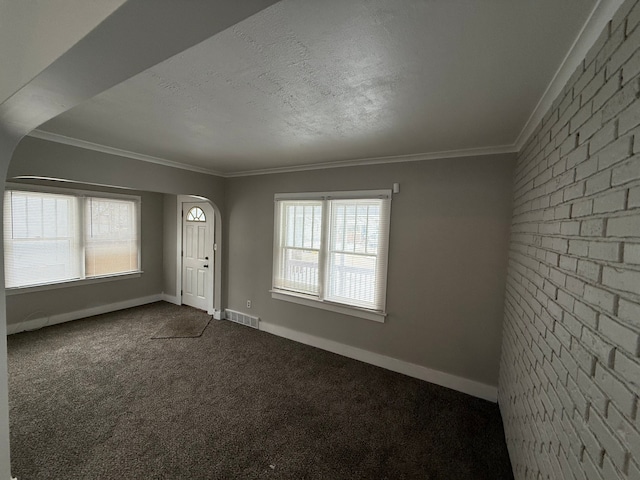 entrance foyer with carpet flooring, plenty of natural light, and crown molding