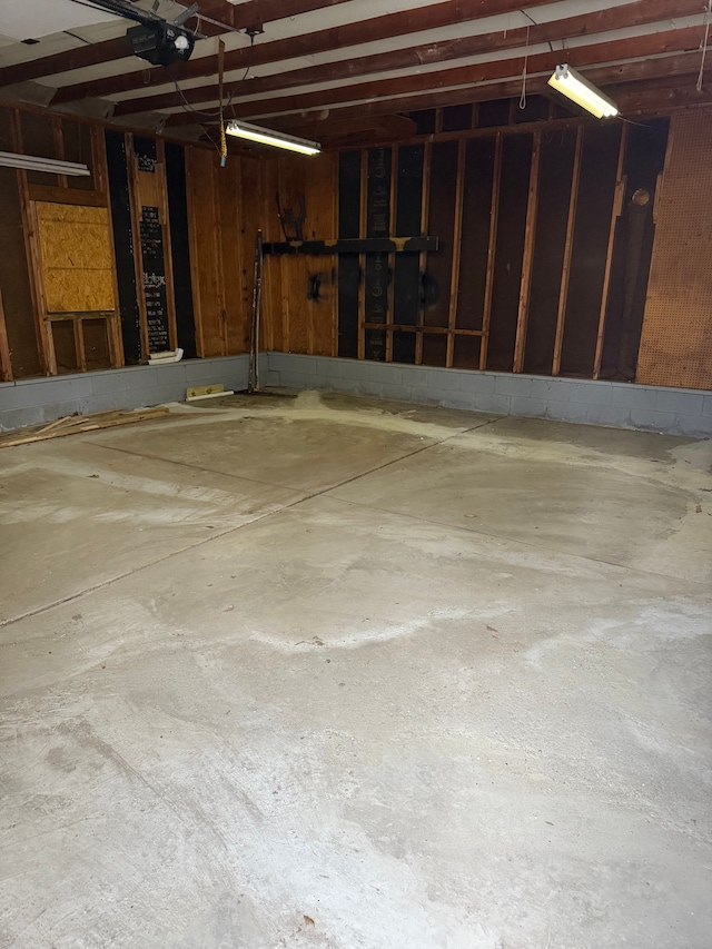 garage with wooden walls and a garage door opener