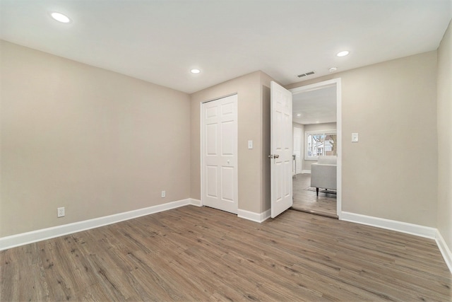 unfurnished bedroom with hardwood / wood-style flooring