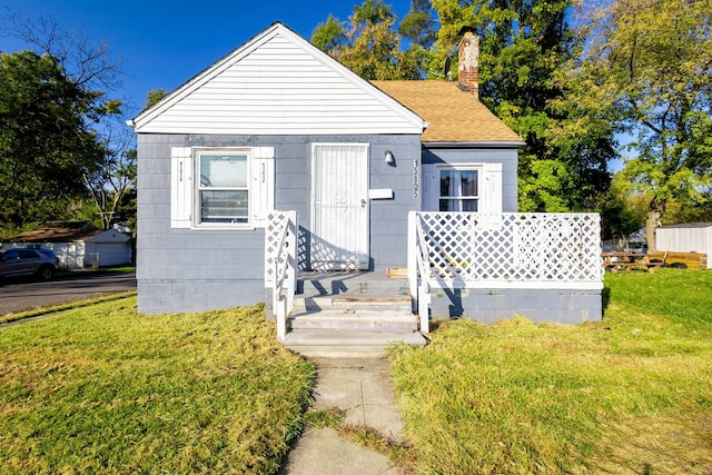 bungalow-style home featuring a front yard