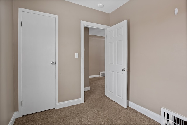 unfurnished bedroom with a closet and carpet flooring