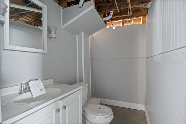 bathroom with concrete floors, toilet, and vanity