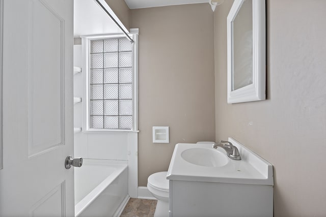 bathroom featuring toilet, vanity, and a bathing tub