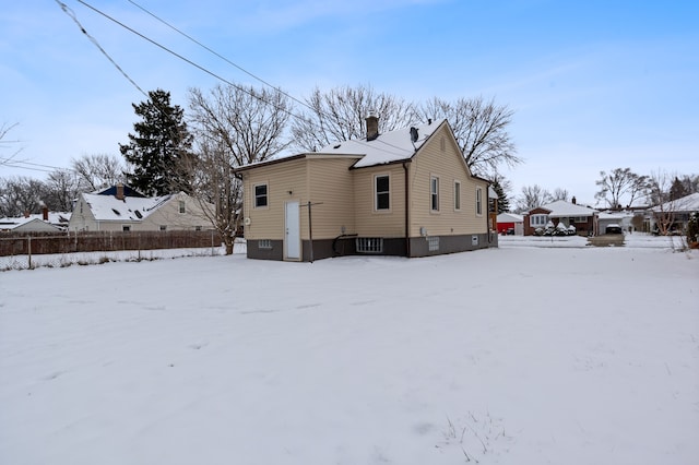 view of snow covered rear of property