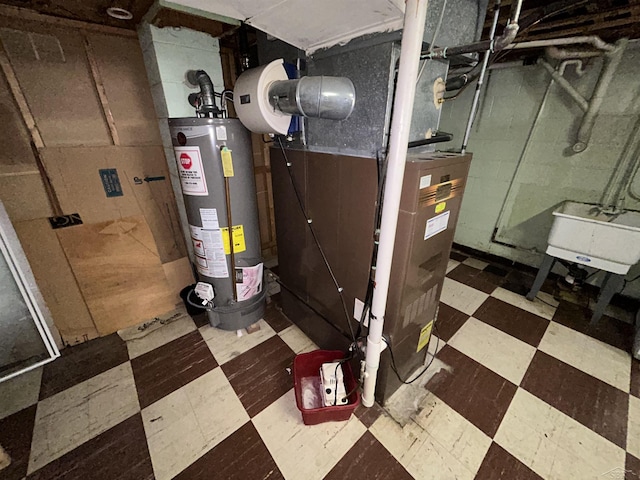 utility room featuring heating unit, sink, and gas water heater