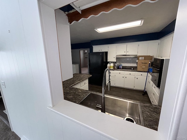 kitchen featuring decorative backsplash, white cabinetry, sink, and black appliances