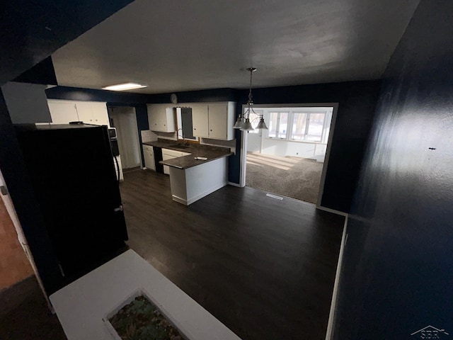 kitchen with pendant lighting, an inviting chandelier, dark hardwood / wood-style floors, and white cabinetry