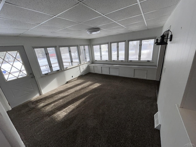 unfurnished sunroom featuring a paneled ceiling