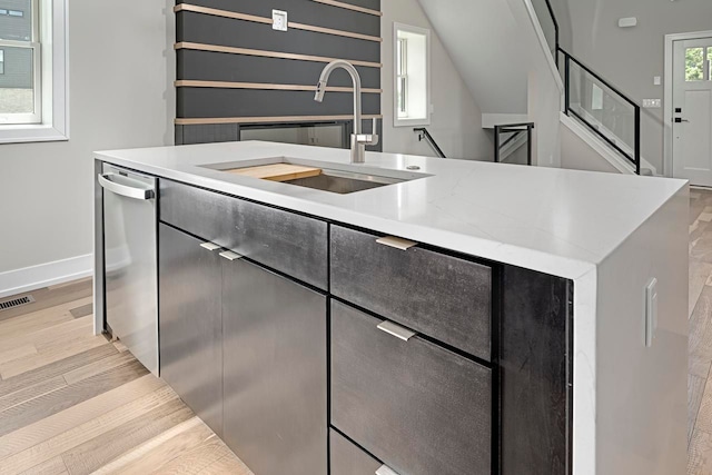3634 Trumbull St Unit 65, Detroit, MI 48208 - kitchen with sink, stainless steel dishwasher, a center island with sink, and light hardwood / wood-style floors