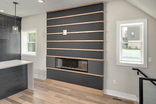 3634 Trumbull St Unit 65, Detroit, MI 48208 - interior space featuring a fireplace, light hardwood / wood-style floors, and vaulted ceiling