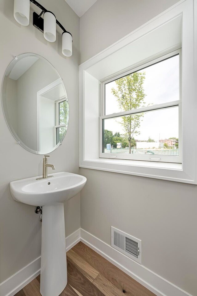 3634 Trumbull St Unit 65, Detroit, MI 48208 - bathroom featuring hardwood / wood-style floors and sink