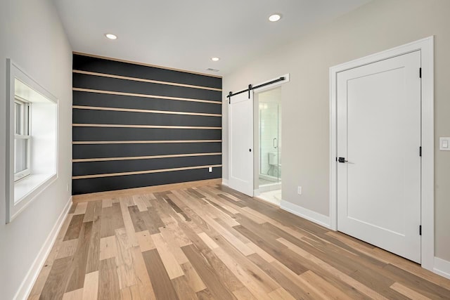 3634 Trumbull St Unit 65, Detroit, MI 48208 - unfurnished room featuring light wood-type flooring and a barn door