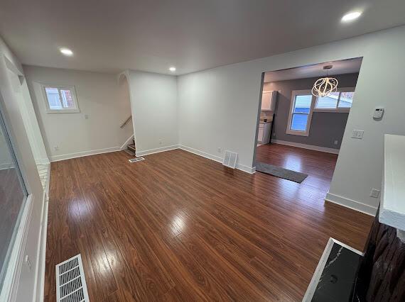 interior space featuring plenty of natural light and dark wood-type flooring