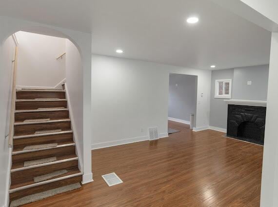 unfurnished living room featuring dark hardwood / wood-style floors