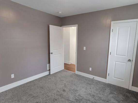 unfurnished room featuring light colored carpet