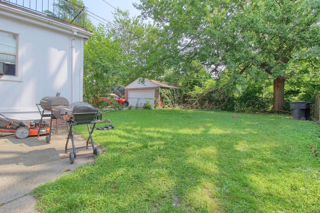 view of yard with a garage and an outdoor structure