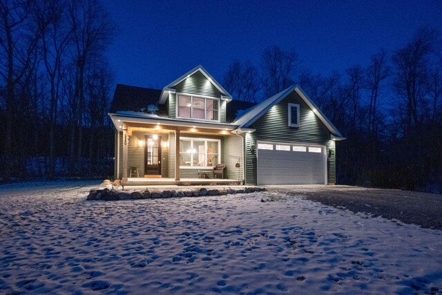 view of front of home featuring covered porch and a garage