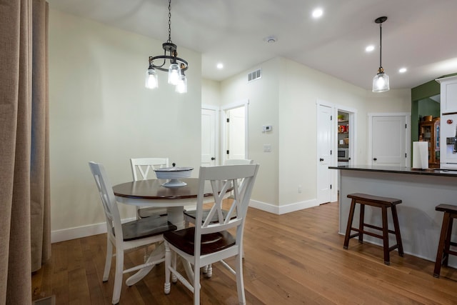 dining area with hardwood / wood-style flooring