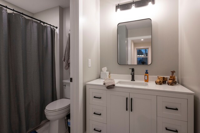 bathroom featuring toilet and vanity