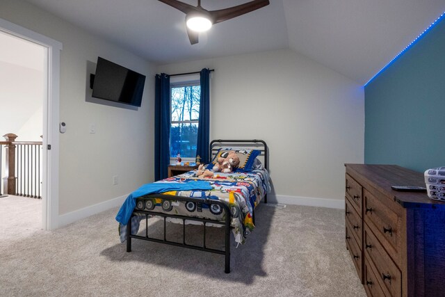 carpeted bedroom with vaulted ceiling and ceiling fan