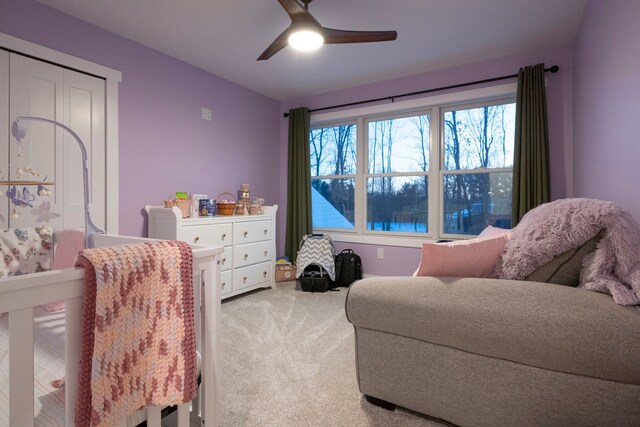 bedroom with ceiling fan, a closet, and carpet flooring