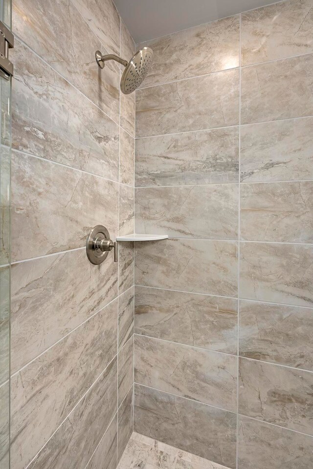 bathroom with a tile shower