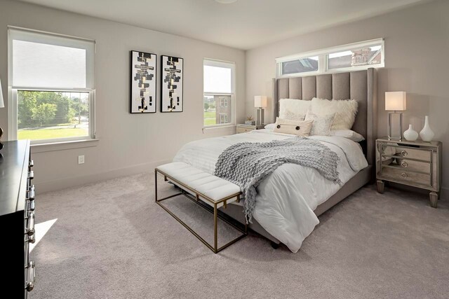 carpeted bedroom with multiple windows