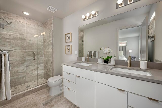 bathroom with vanity, toilet, and an enclosed shower