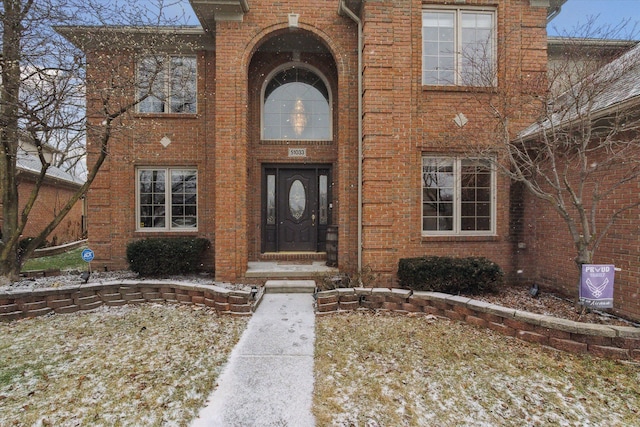 view of snow covered property entrance