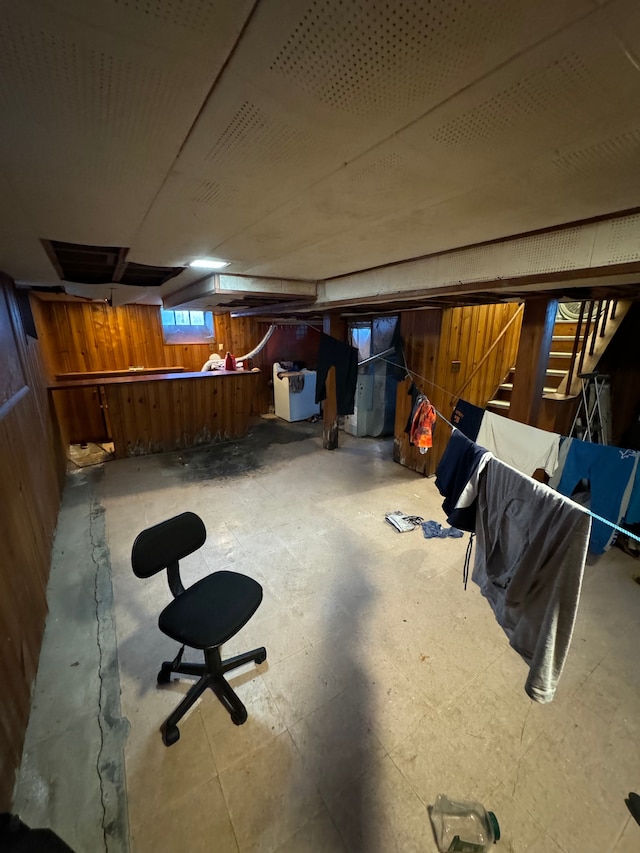 basement featuring wood walls