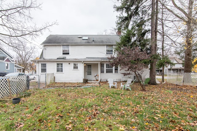 rear view of property with a yard