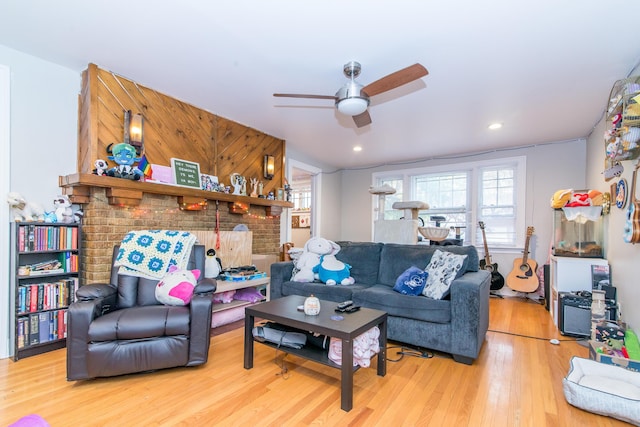 living room featuring ceiling fan and hardwood / wood-style flooring