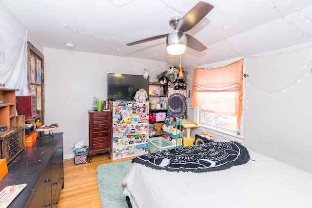 bedroom with ceiling fan and light hardwood / wood-style flooring