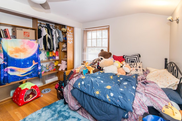 bedroom with ceiling fan, a closet, and wood-type flooring