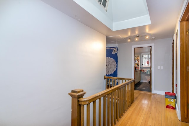 corridor with light hardwood / wood-style floors