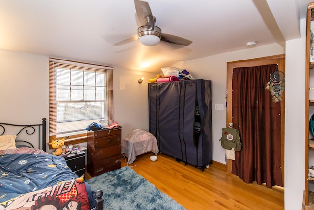 bedroom with ceiling fan and light hardwood / wood-style flooring