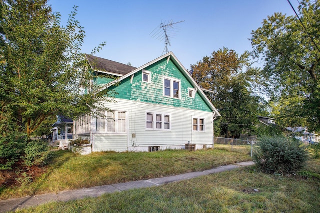 view of property exterior featuring a lawn