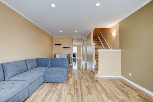 living room featuring light hardwood / wood-style floors and ornamental molding